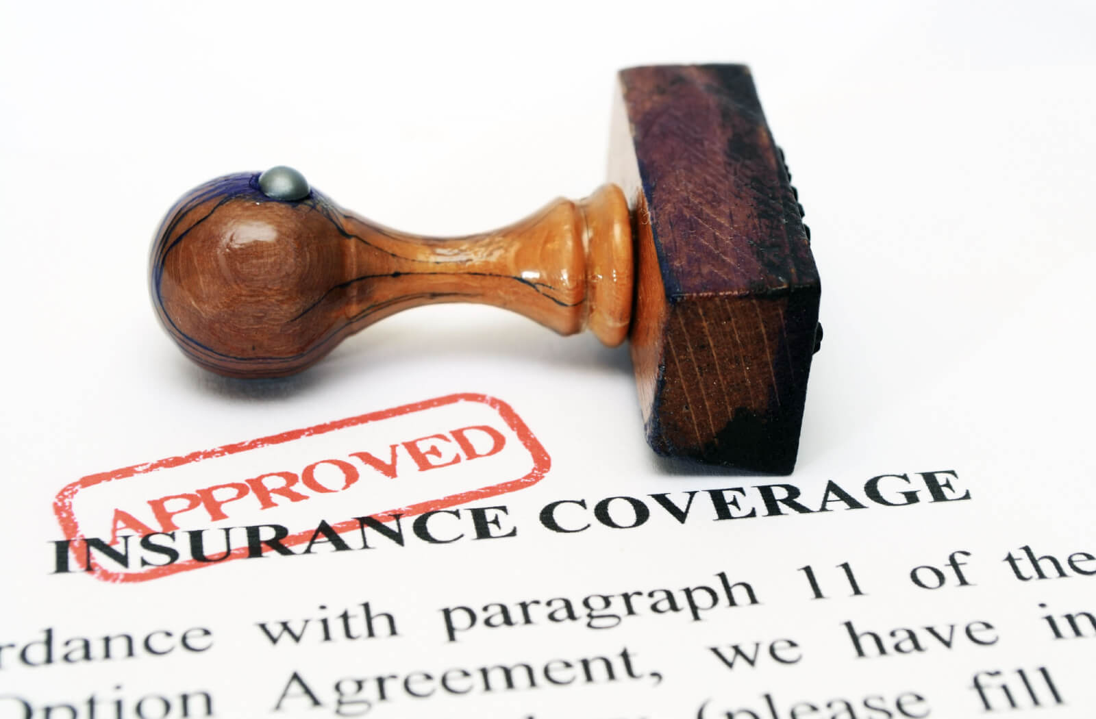 An insurance policy with an approved mark and rubber stamp.