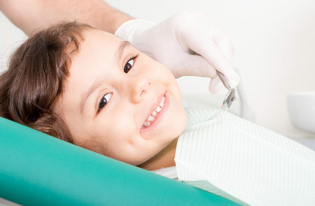 A child smiling at the dentist showing off the results of their Solea laser treatment.