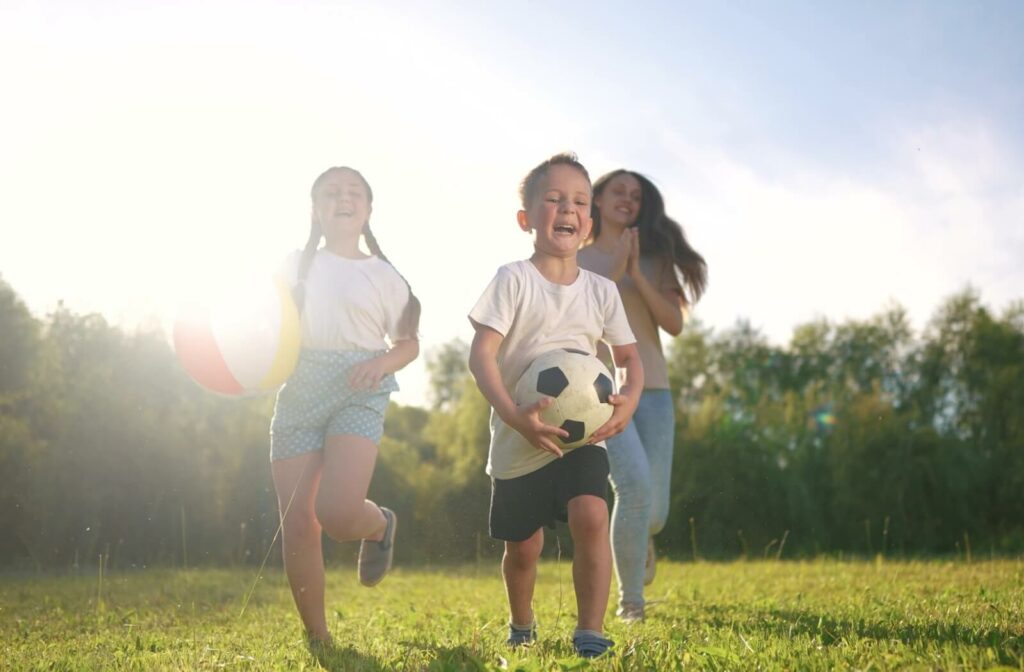 A group of children play outside with a ball.