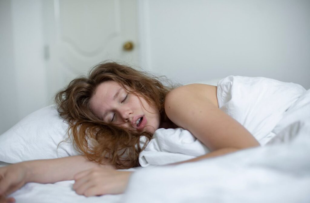 Adult sleeping with mouth open, illustrating mouth breathing during sleep.