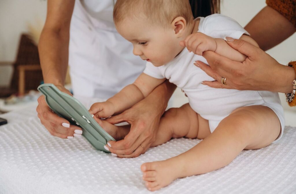 A baby is playing with their parents.